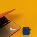 AirPods 2 in a Navy Blue Case on a Yellow Background Beside a Laptop  screen for extension Chrome web store in OffiDocs Chromium