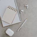 AirPods 3 Beside a Notebook and a White Pen  screen for extension Chrome web store in OffiDocs Chromium