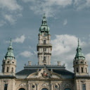 A large building with a clock tower and a blue sky  screen for extension Chrome web store in OffiDocs Chromium