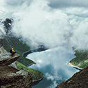 A man sits at the edge of Trolltunga  screen for extension Chrome web store in OffiDocs Chromium