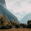 Brown Wooden House Near Tall Trees and Mountains  screen for extension Chrome web store in OffiDocs Chromium