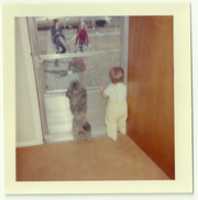 Free download Child and a dog looking through a door at three people free photo or picture to be edited with GIMP online image editor