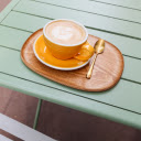 Elegance in Every Sip: Cappuccino on a Green Table  screen for extension Chrome web store in OffiDocs Chromium