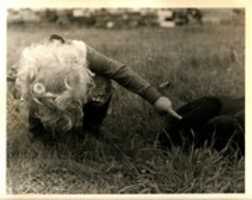 Free download Eli in the grass poking our puppy Mud free photo or picture to be edited with GIMP online image editor