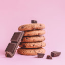 Four Chocolate Chip Cookies Stacked on a Pink Background  screen for extension Chrome web store in OffiDocs Chromium