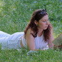 Girl reading a book on the grass garden  screen for extension Chrome web store in OffiDocs Chromium