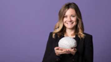 Free download Girl smiling while holding a fake brain free photo or picture to be edited with GIMP online image editor