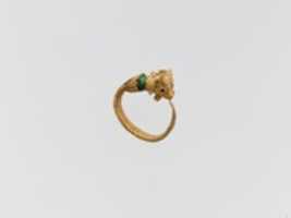 Free download Gold earring with two bulls heads and glass bead free photo or picture to be edited with GIMP online image editor