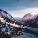 Green Trees on a Snow Covered Mountain Under Night Sky  screen for extension Chrome web store in OffiDocs Chromium