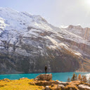 Hiker on a Rock Above a Mountain Lake in the Swiss Alps  screen for extension Chrome web store in OffiDocs Chromium