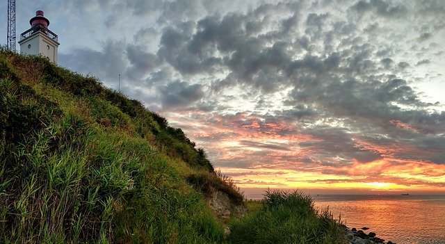 Unduh gratis Lighthouse Sunset Sea - foto atau gambar gratis untuk diedit dengan editor gambar online GIMP