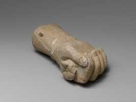 Free download Limestone statue fragment of a right hand with a bracelet, holding a flower free photo or picture to be edited with GIMP online image editor