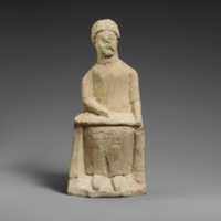 Free download Limestone statuette of a seated beardless male votary writing on a scroll free photo or picture to be edited with GIMP online image editor