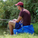 Man sitting in bushes fishing  screen for extension Chrome web store in OffiDocs Chromium