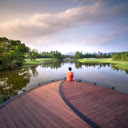 Man sitting in front of a large lake with green trees  screen for extension Chrome web store in OffiDocs Chromium