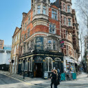 People Walking Outside the Bloomsbury Tavern  screen for extension Chrome web store in OffiDocs Chromium