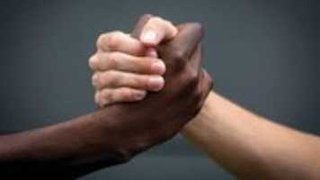 Free download Photo of a light-skinned hand and a dark-skinned hand grabbing each other free photo or picture to be edited with GIMP online image editor