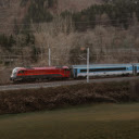 Red Railjet Train Traversing Scenic Mountainous Landscape  screen for extension Chrome web store in OffiDocs Chromium