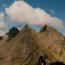 Rocky rough mountains under bright cloudy blue sky  screen for extension Chrome web store in OffiDocs Chromium