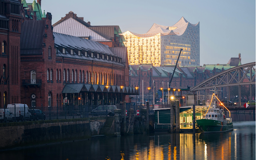 A boat is docked in a river near a building  from Chrome web store to be run with OffiDocs Chromium online