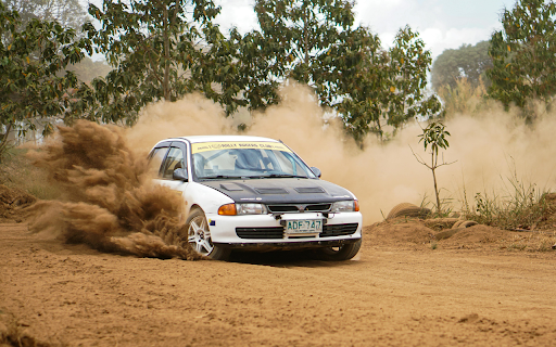 A car driving on a dirt road with dust flying up  from Chrome web store to be run with OffiDocs Chromium online