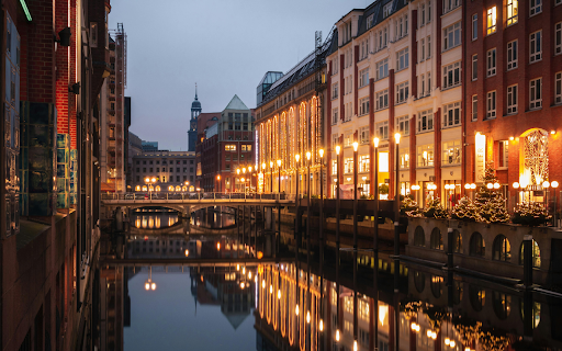 A city with buildings and a canal at night  from Chrome web store to be run with OffiDocs Chromium online