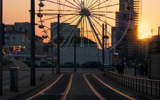A ferris wheel at sunset on a street  from Chrome web store to be run with OffiDocs Chromium online