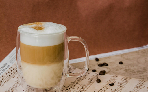 A Foamy Latte in a Glass Cup on a Music Sheet  from Chrome web store to be run with OffiDocs Chromium online