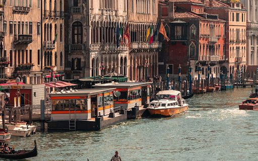 A gondola is floating down a canal in venice  from Chrome web store to be run with OffiDocs Chromium online
