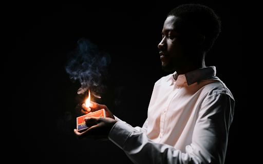A Man Holding a Burning Match Stick  from Chrome web store to be run with OffiDocs Chromium online
