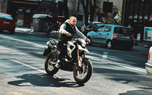 A Man Riding a Motorcycle on the Road  from Chrome web store to be run with OffiDocs Chromium online
