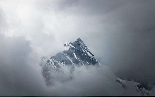 A mountain is seen in the clouds with a cloudy sky  from Chrome web store to be run with OffiDocs Chromium online