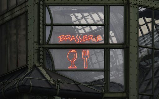A neon sign in front of a building  from Chrome web store to be run with OffiDocs Chromium online