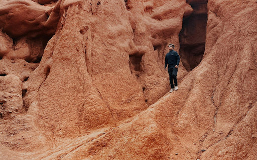 A Person Standing by a Rock Formation  from Chrome web store to be run with OffiDocs Chromium online