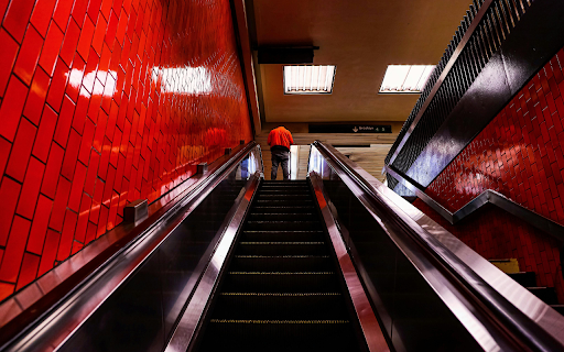 A Person Standing on the red Escalator  from Chrome web store to be run with OffiDocs Chromium online