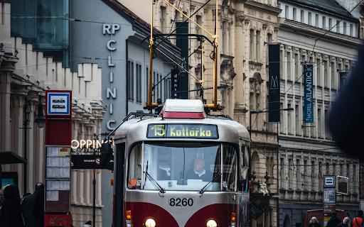 A red and white tram on a city street  from Chrome web store to be run with OffiDocs Chromium online
