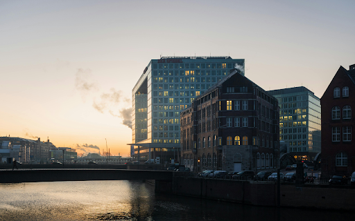 A river with buildings in the background at sunset  from Chrome web store to be run with OffiDocs Chromium online