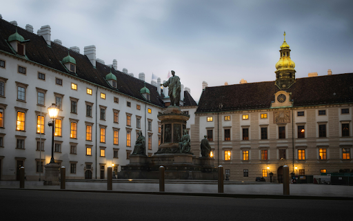 A statue is in front of a building at dusk  from Chrome web store to be run with OffiDocs Chromium online