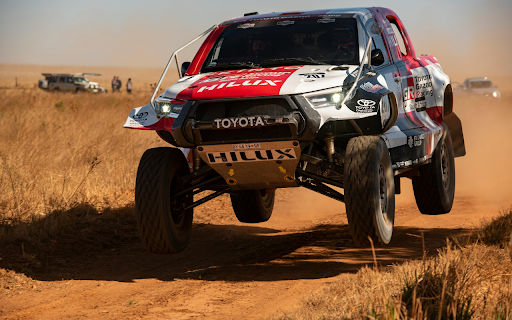 A white car driving on a dirt road  from Chrome web store to be run with OffiDocs Chromium online