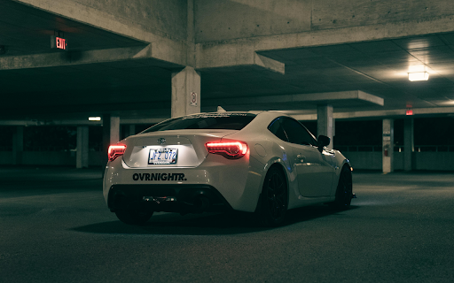 A white sports car parked in a parking garage  from Chrome web store to be run with OffiDocs Chromium online