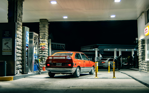 Back View of Red Volkswagen Gol at Gas Station  from Chrome web store to be run with OffiDocs Chromium online