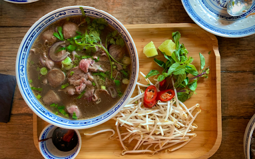 Beef Pho on a Wooden Tray with Garnishes  from Chrome web store to be run with OffiDocs Chromium online