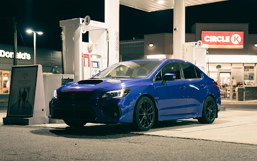 Blue Car at Nighttime Gas Station Stop  from Chrome web store to be run with OffiDocs Chromium online