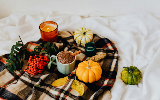 Brown Ceramic Mug and Pumpkins on a Checkered Fabric  from Chrome web store to be run with OffiDocs Chromium online