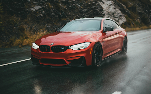 Driving a Red BMW Sportscar on the Wet Road  from Chrome web store to be run with OffiDocs Chromium online