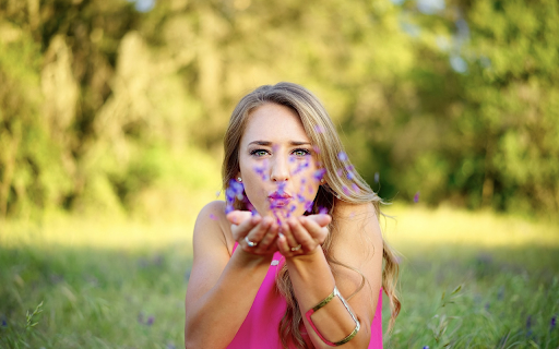 Girl blowing flower petals  from Chrome web store to be run with OffiDocs Chromium online
