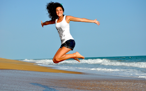 Girl jumping on the beach  from Chrome web store to be run with OffiDocs Chromium online