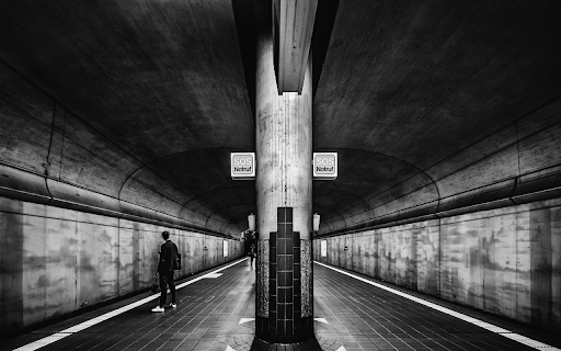 Grayscale Photo of a Person Standing on Subway Platform  from Chrome web store to be run with OffiDocs Chromium online
