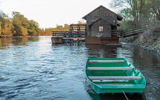 Green wooden boat on the river bank  from Chrome web store to be run with OffiDocs Chromium online