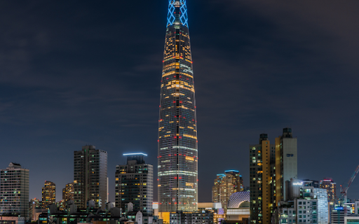 Illuminated Skyscraper Dominating the Night Skyline  from Chrome web store to be run with OffiDocs Chromium online